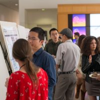 Poster session busy with people discussing science