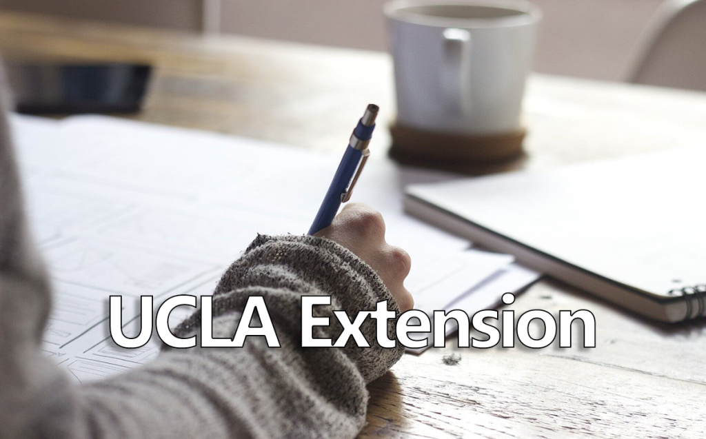 Close-up shot of someone writing notes with "UCLA Extension" written across the image